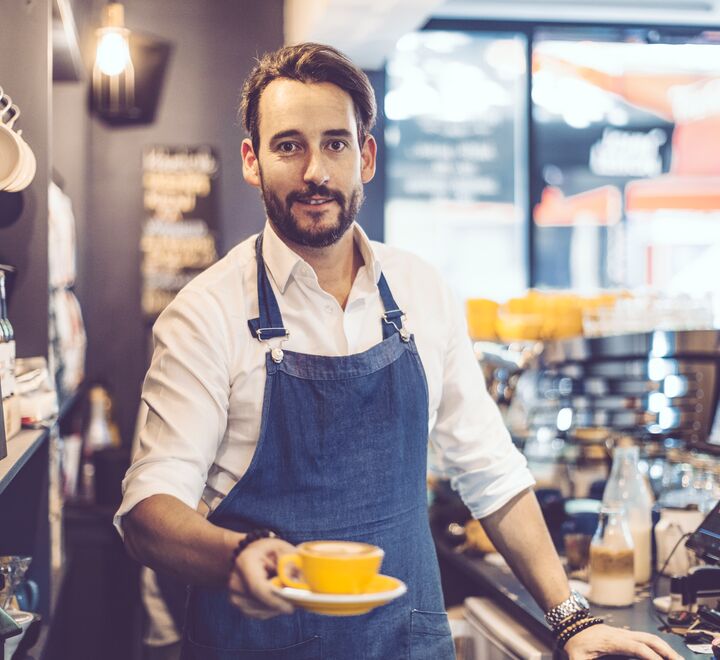 A barista (pictured) serving specialty coffee, which new research claim is a drink we enjoy more in certain atmospheres.