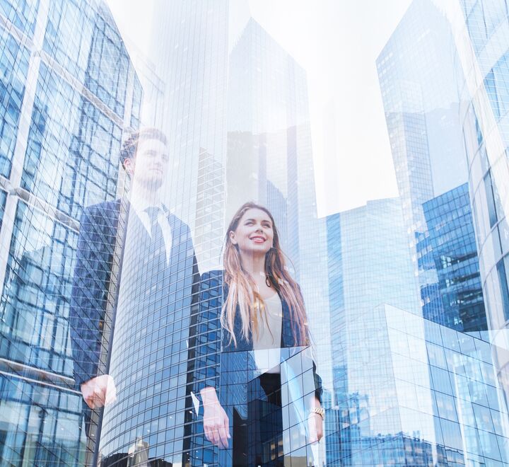  Man and woman looking up at skyscrapers