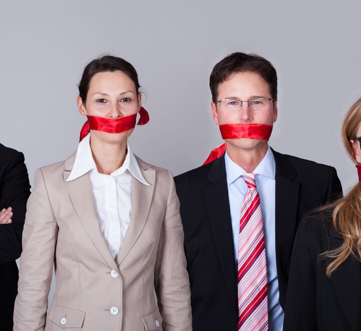 Illustration: employees with red tape covering their mouths
