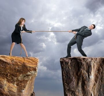 Illustration: man and woman on a mountain pulling a rope between them