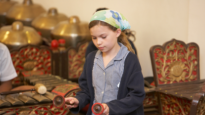 Gamelan Group Workshops - Autumn Girl playing the Gamelan