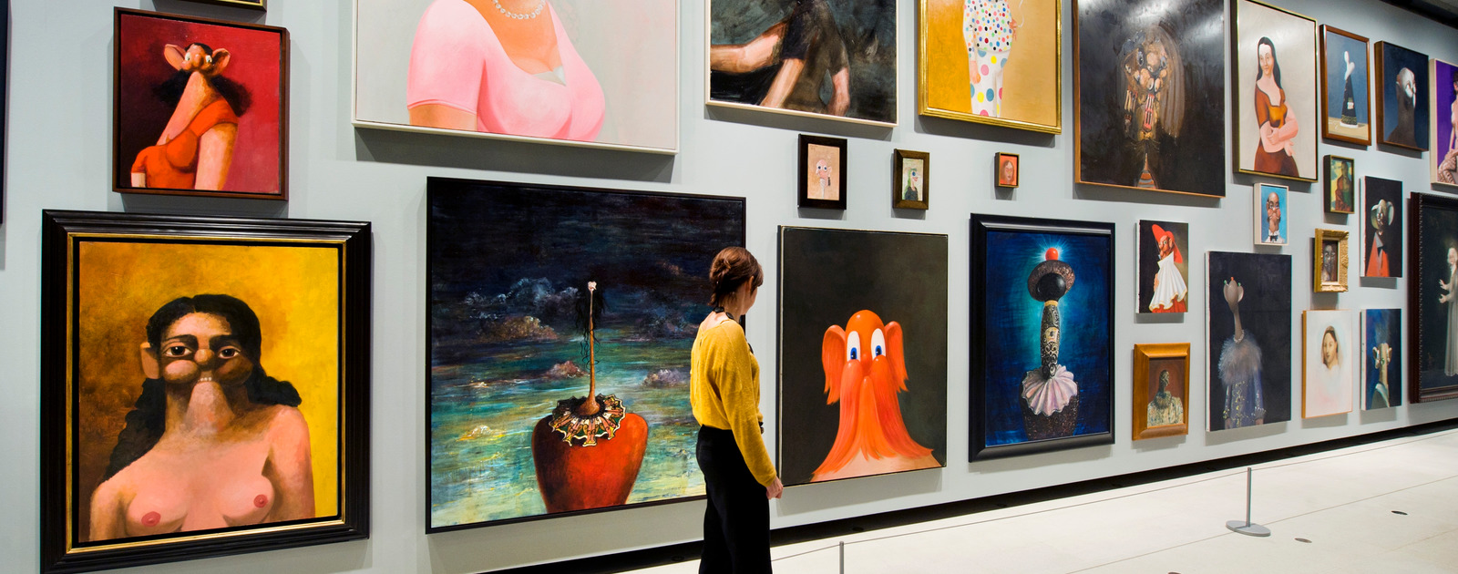 Paintings by GEORGE CONDO at MENTAL STATES Exhibition at Hayward Gallery 2011 Visitor Looking at Paintings on Wall by artist, GEORGE CONDO at Hayward Gallery
