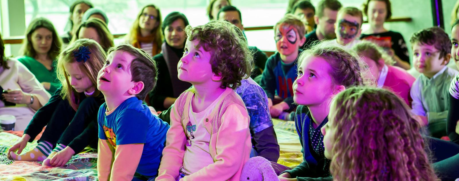 THE GIANT STORYTELLING BED at Imagine Children's Festival Credit Victor Frankowski 2016 Children Listening on THE GIANT STORYTELLING BED at Imagine Children's Festival