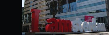 I Amsterdam logo in front of office building