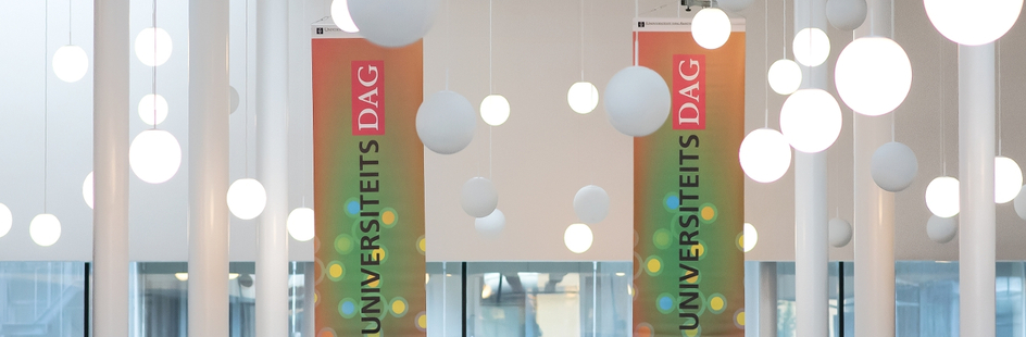 Picture of University Day flags in one of the UvA Buildings
