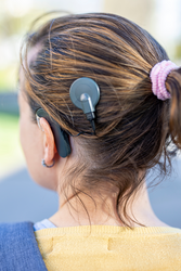 Woman head with cochleral implant hearing aid