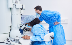 Researchers work on microscope in laboratory during Covid-19 pandemic looking for vaccine