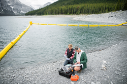 Ecologists testing water with equipment at lakeside