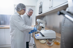 Workers testing food in biscuit factory