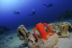 Amphora from ship wreck with divers Shutterstock ID 96499835