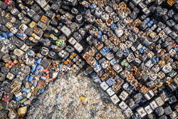 Illegal storage of solid household waste, plastic bottles and garbage bags. Land pollution. Aerial top view.