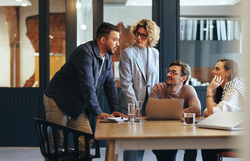 Team of professionals having a meeting in a digital marketing agency. Business people discussing a project in an office. Teamwork and collaboration in a creative workplace.