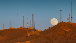 Super Moon Rising over Red Mountain in Reno Nevada with Radio Towers