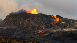 Beautiful aerial view at night of the Active Volcano with red Lava in Iceland