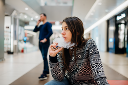 Woman using electronic cigarette to smoke in public places.Smoke restriction,smoking ban.Using vaping device with flavored liquid.New vaping technology.Give up tobacco.Smoking habit,nicotine addict