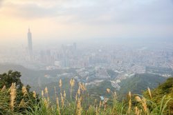 Panoramic aerial view of foggy and overpopulated Taipei City, Taipei 101 with Xinyi Commercial area, Tamsui River and downtown area at dusk ~ Scenery of Taipei City with hazy polluted air