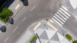 aerial top view of street with parking lot near new residential housing complex