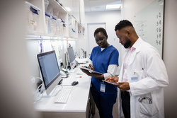 Doctor and nurse with digital tablet consulting in clinic