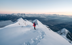 Panoramic banner of man trekking in snow covered mountain. Sport  concept. Silhouette trail hiker in mountain summit background. Hiker on the or alpiniston run training outdoors active fit lifestyle.