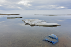 Plastic container in the glacial lake on the island of the high Arctic - environment pollution