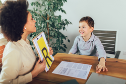 Shot of a speech therapist during a session with a little boy 