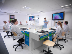 Apprentice dentists learning from professional using screens in dentist college