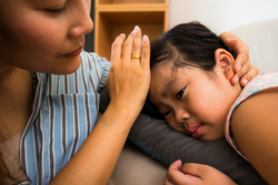 mother and sick boy,sitting on sofa